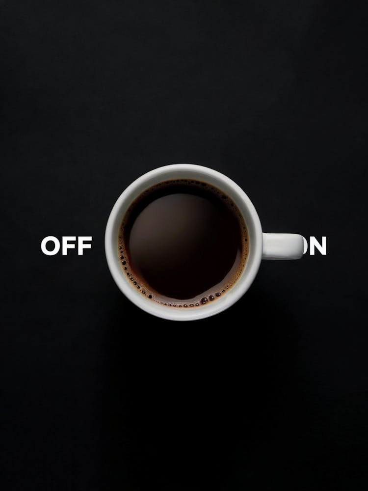 Coffee Cup as a Creative On Off Switch Concept  DESCRIPTION A coffee cup symbolizing an on off switch on a black background, representing the energizing effect of coffee. Ideal for concepts related to motivation, creativity, and productivity.