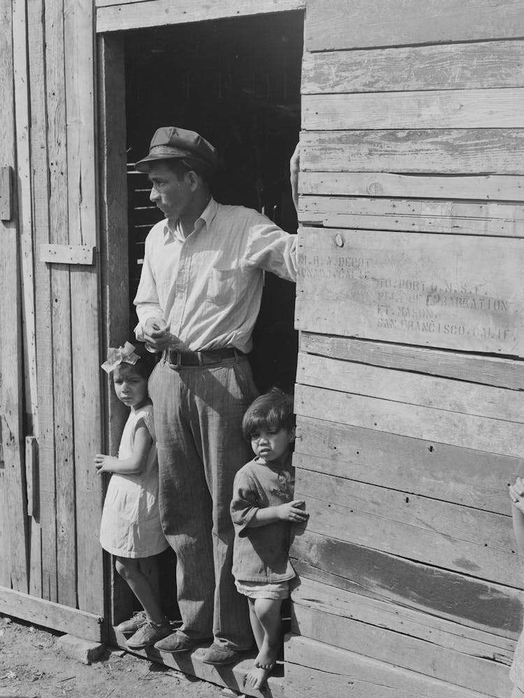 Untitled Photo, Possibly Related To Mexican Father And Children In Doorway Of Their Home Made Of Scrap Lumber