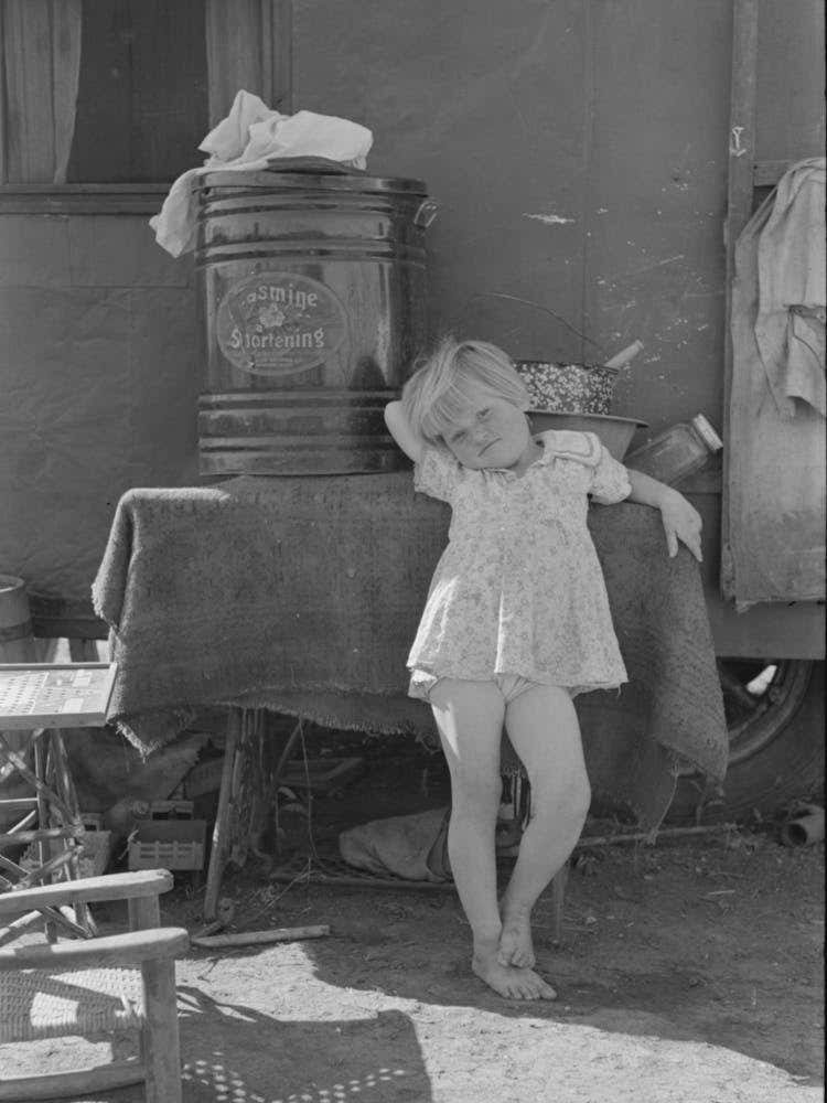 Untitled Photo, Possibly Related To Child Of Migrant Family In Front Of Household Goods Of Trailer Home