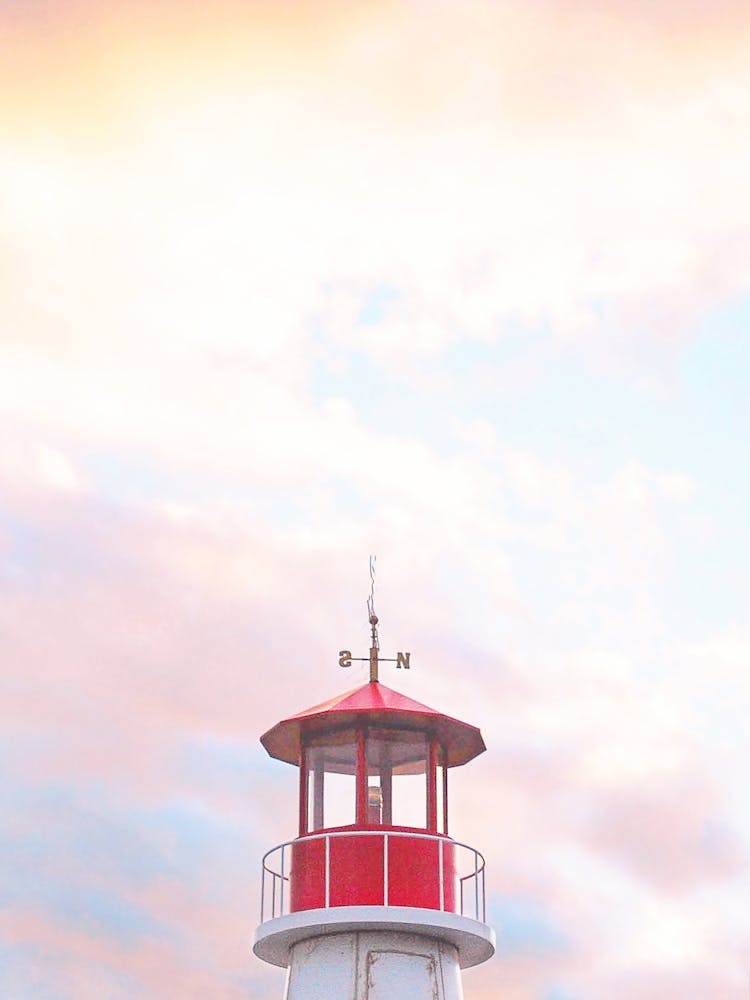 New York, USA I Coney Island lighthouse pink sky from sunset sky to candy pink pastel aesthetic coastal photography red in color on the beach of the east coast of USA for a seaside coastal home