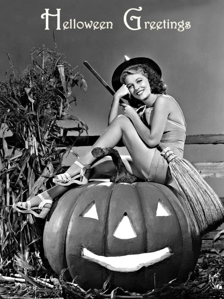 Pin=Up Witch Girl Posing On A Big Pumpkin With A Broom