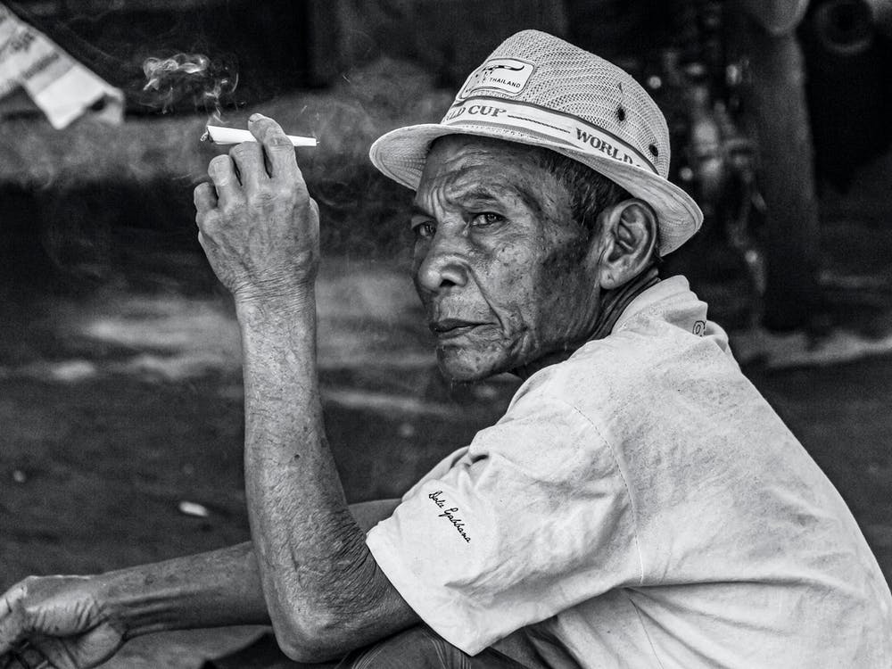 Old Man Smoking A Cigarette
