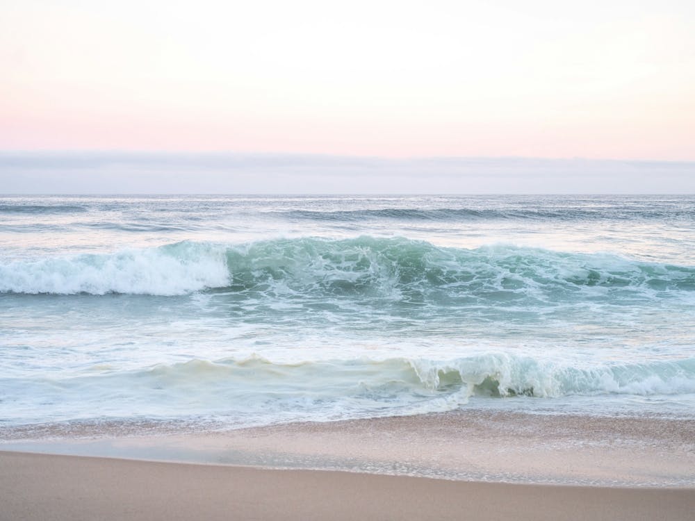 Pastel pink sunrise at Praia da Adraga Portugal - summer beach nature and travelphotography by Christa Stroo Photography