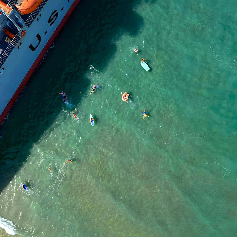 Ocean Adventure – Exploring Waves Near a Mighty Vessel