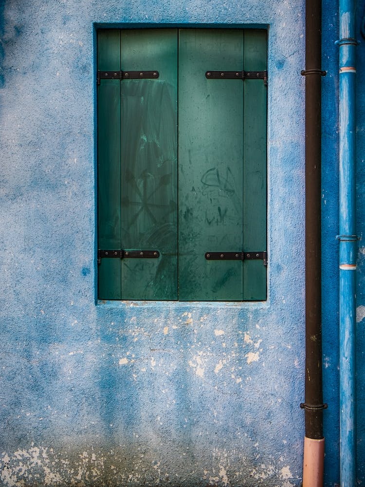 Drainpipes And Shuttered Window