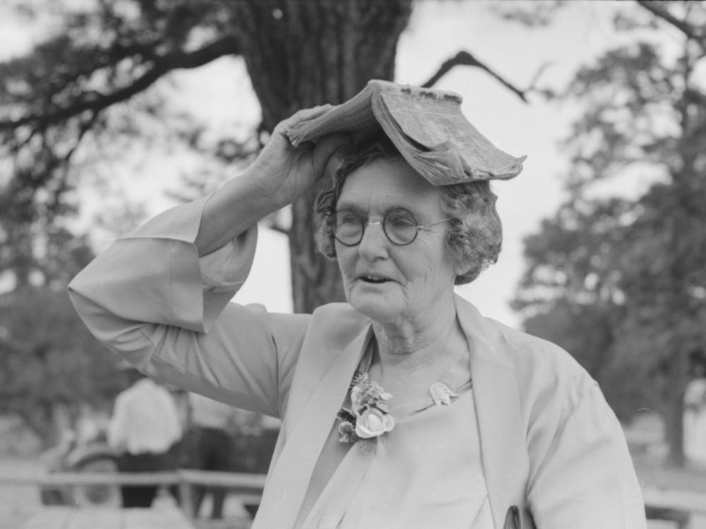 Farm Woman Using Songbook As Sunshade During Dinner At All Day Community Sing, Pie Town, New Mexico