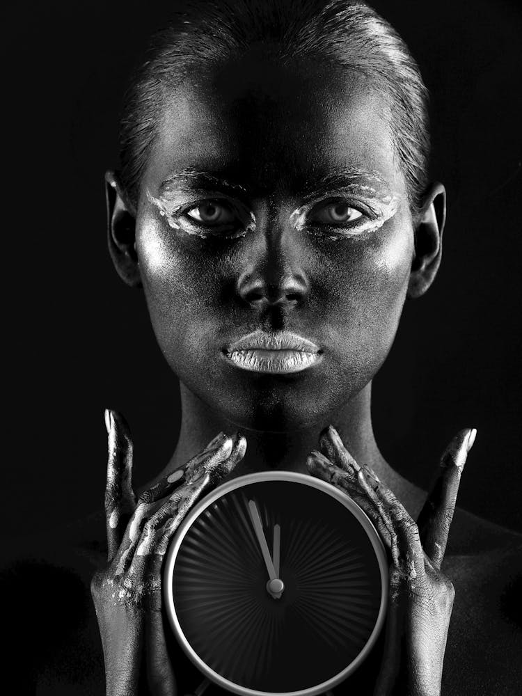 Black Woman Holding A Clock