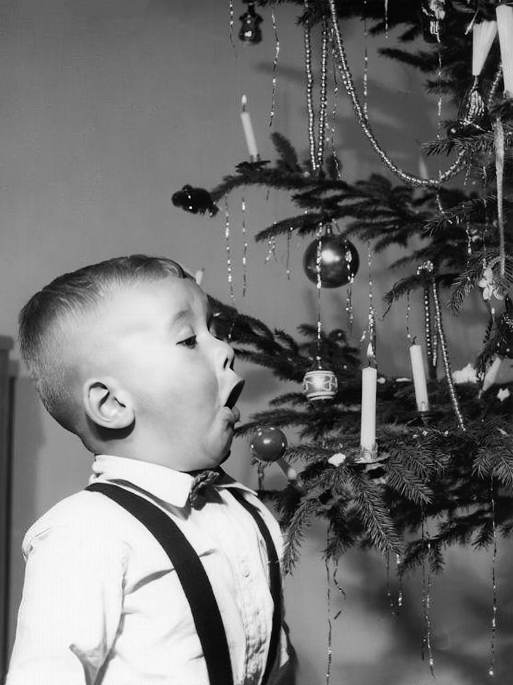 Boy With A Christmas Tree, Blowing Out Candle, Vintage Black and White Old Photo