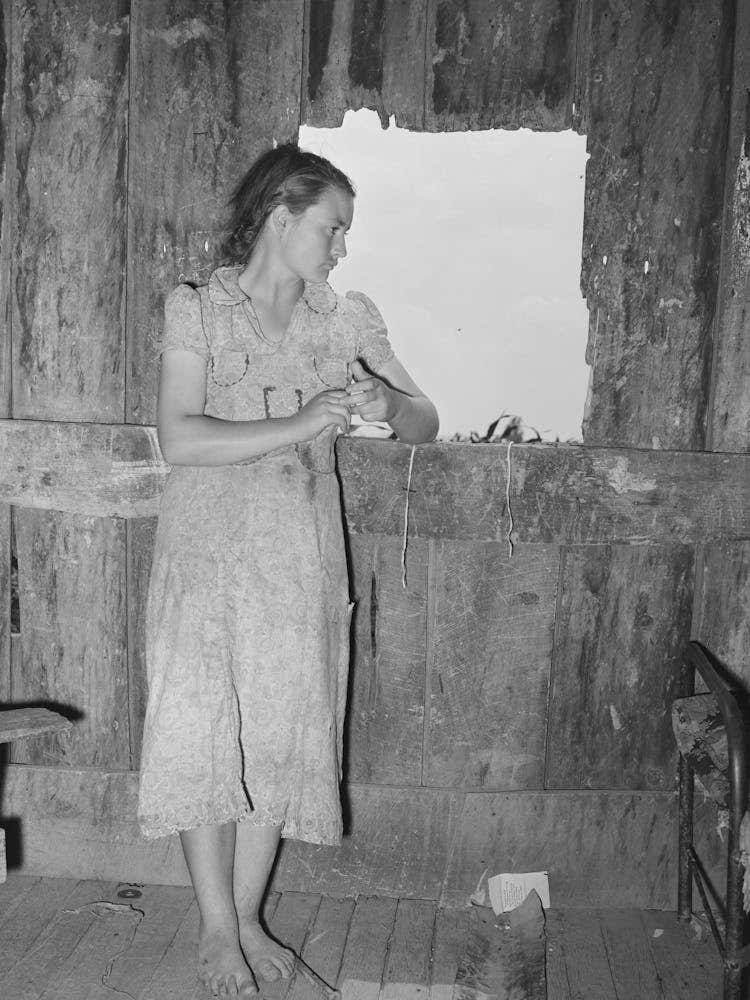 Daughter Of Agricultural Day Laborer Looking Out The Unshuttered Window Of The Desolate Shack Which Was Her Ho