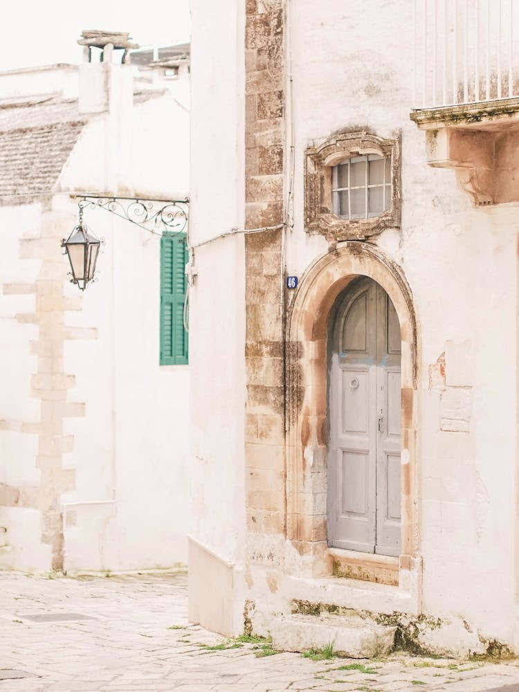 Puglia, Italy I Deserted street with Italian Baroque architecture and vintage retro door photography in damaged condition with summer pastel aesthetic of la dolce vita in a countryside village in south