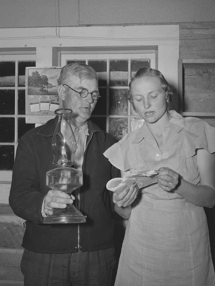 Mr, Besson, President Of The Literary Society Holds The Lamp For Mrs, Caudill, Secretary, During A Song At The Literary 1