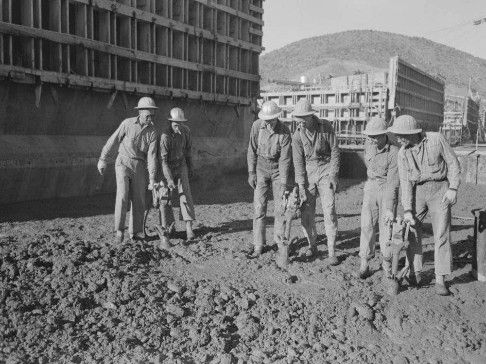 Untitled Photo, Possibly Related To Workmen Using Viberators Which Spread The Wet Concrete In Construction Of