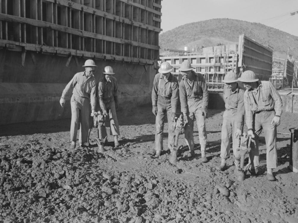 Untitled Photo, Possibly Related To Workmen Using Viberators Which Spread The Wet Concrete In Construction Of