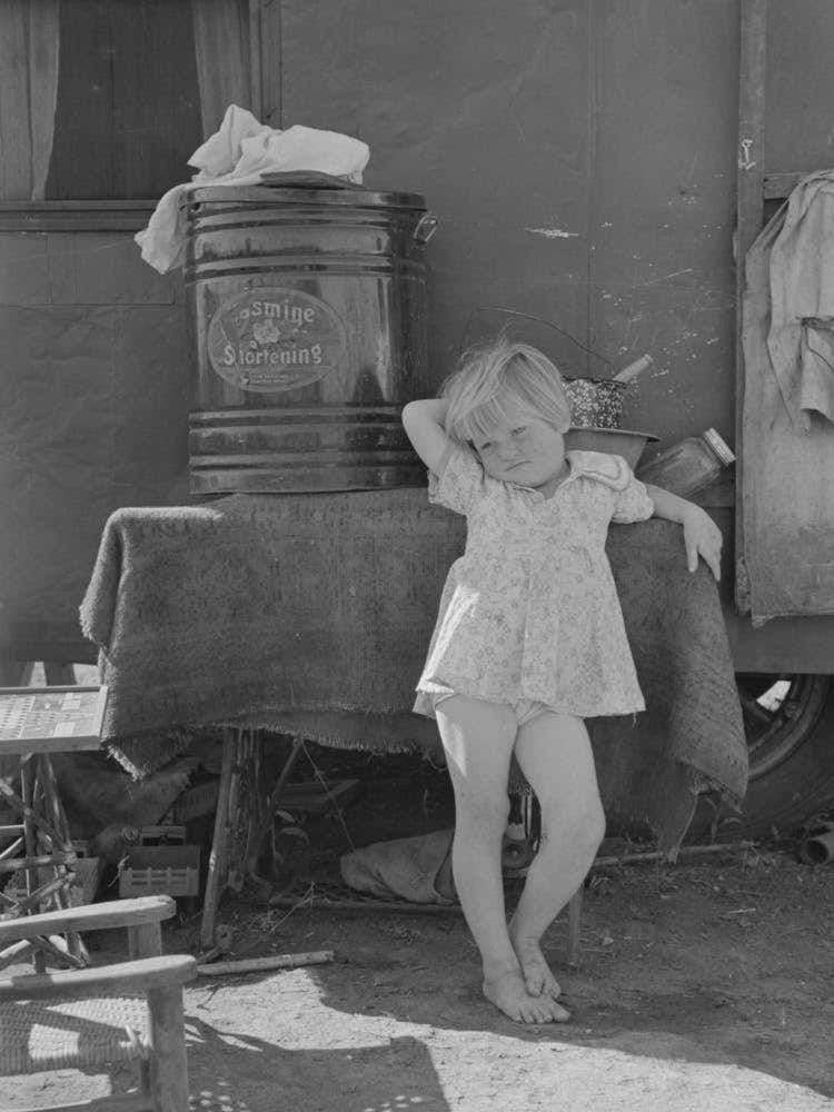 Child Of Migrant Family In Front Of Household Goods Of Trailer Home, Weslaco, Texas By Russell Lee