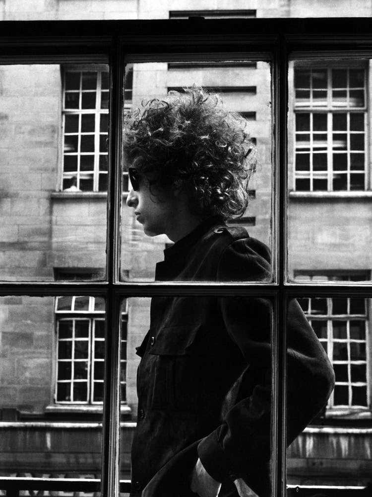 American Singer Bob Dylan Pictured Walking Past A Shop Window During His Visit To London