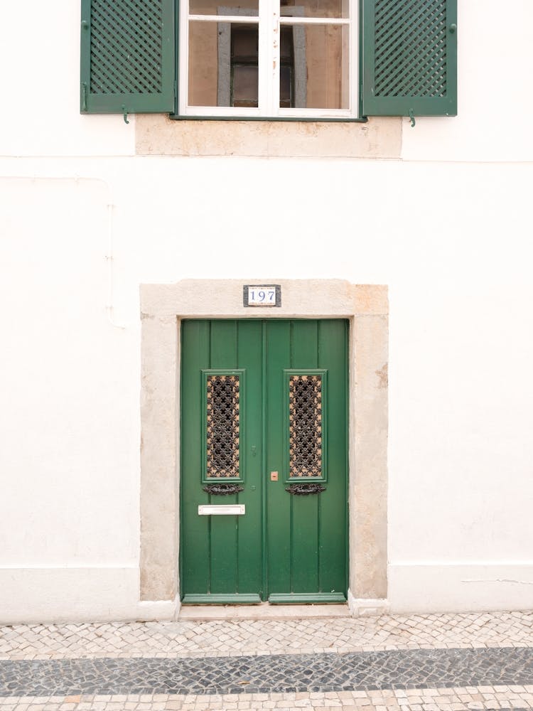 The green door nr. 197 in Ericeira, Portugal - summer architecture and travel photography by Christa Stroo Photography