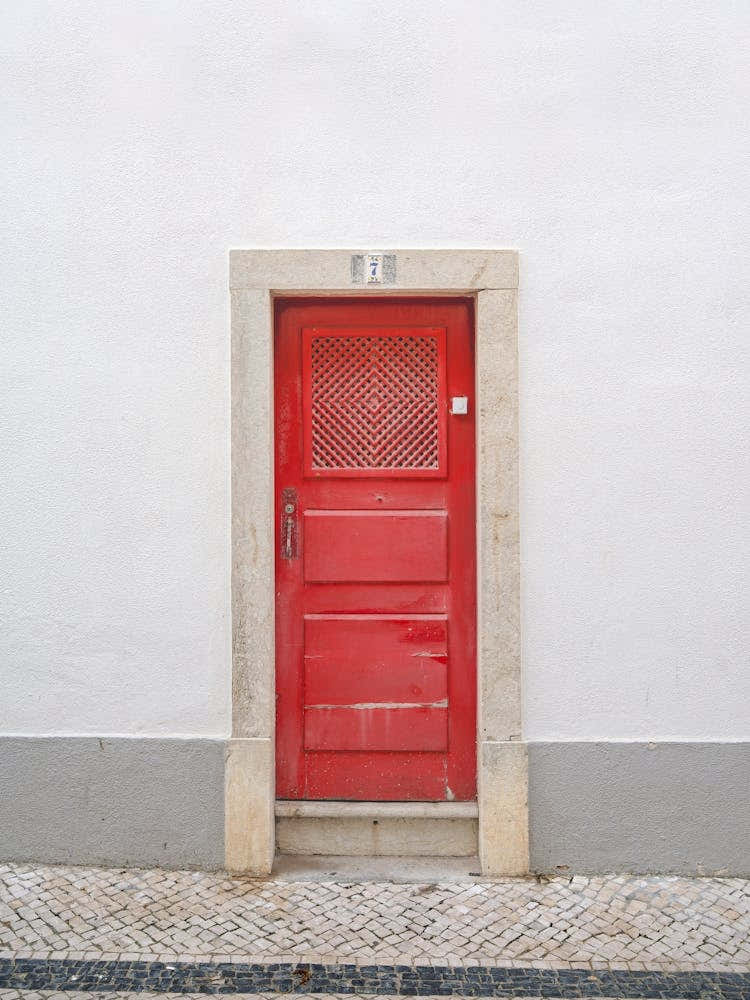 The red door nr. 7 in Ericeira, Portugal - minimalist summer street and travel photography by Christa Stroo Photography