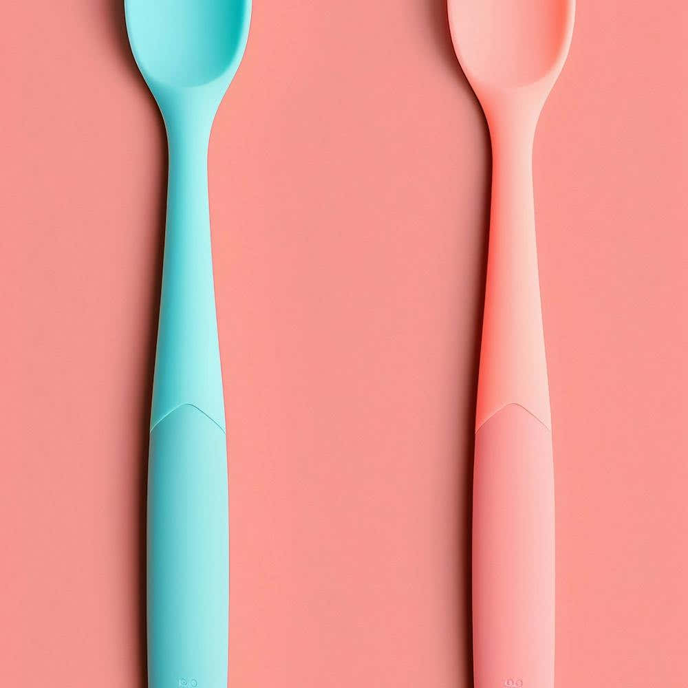 Two Spoons On A Pink Background