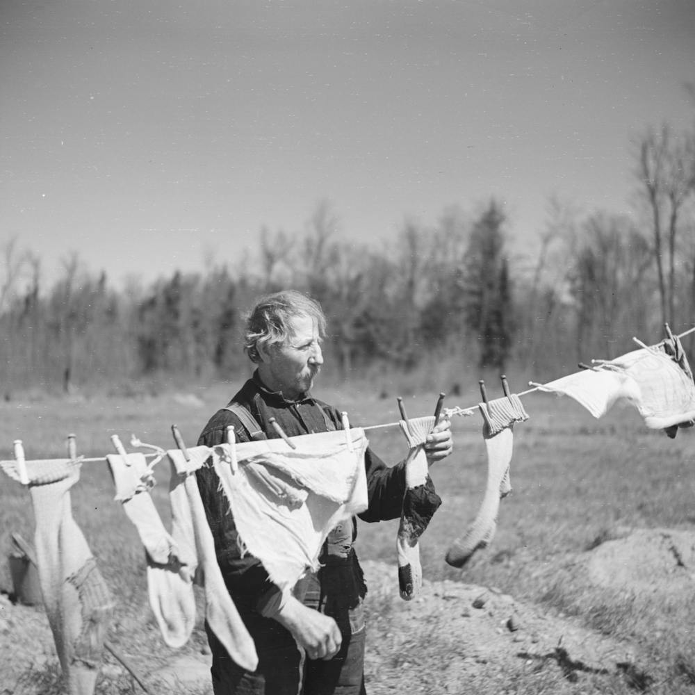 Untitled Photo, Possibly Related To John Bastia Hanging Up His Laundry, He Is A Single Shacker In Iron County, Michigan