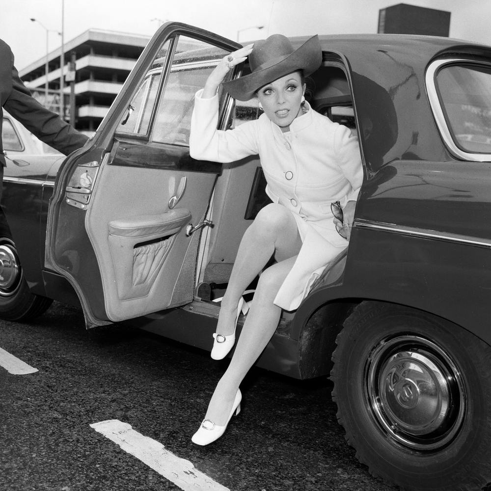 Joan Collins At Heathrow Airport, Wearing Dior 1969