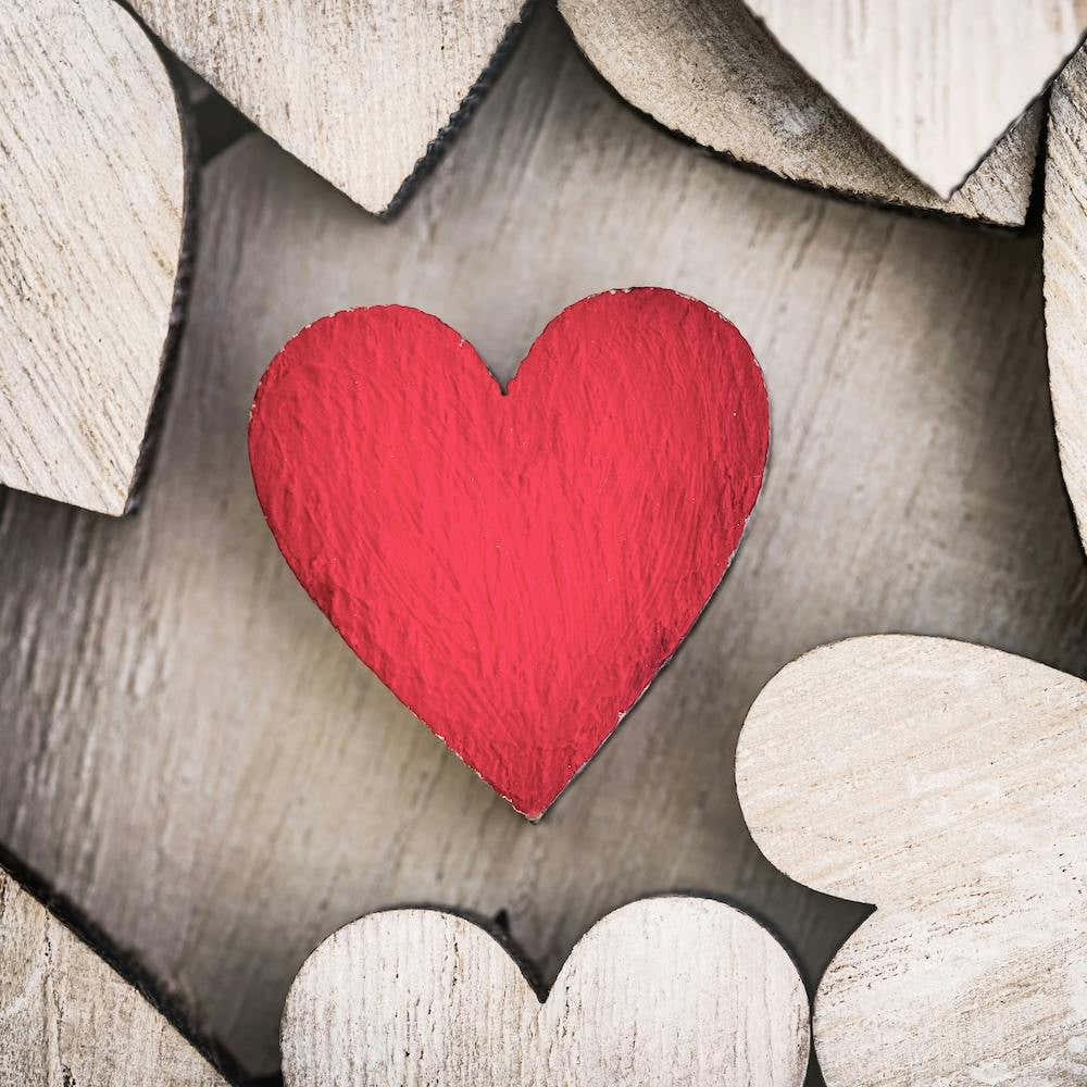 Red wooden love heart background for a romantic message for Valentines day