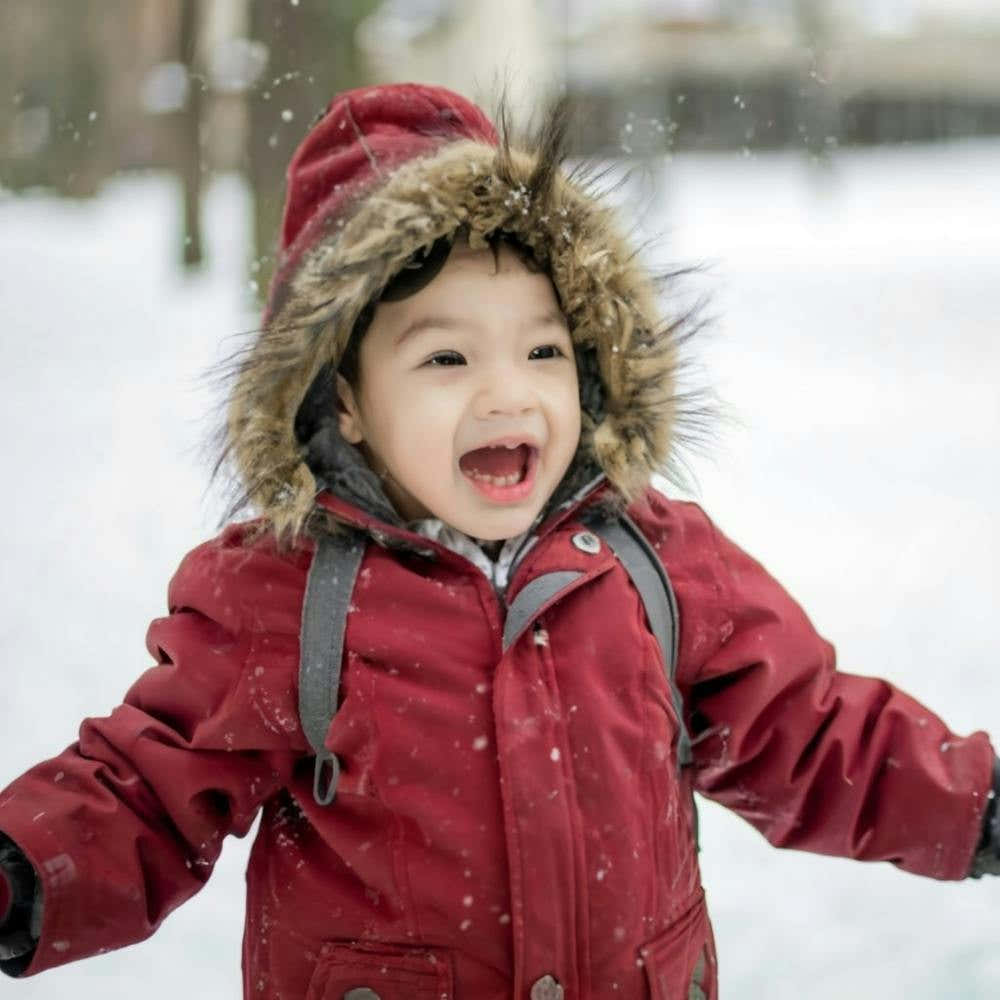 Child Playing In The Snow