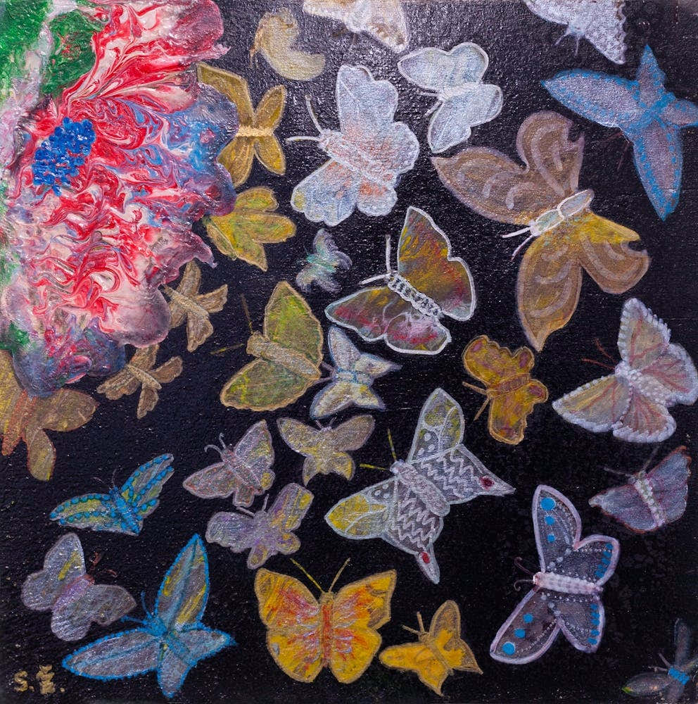 "Butterflies fly toward the fiery flower."