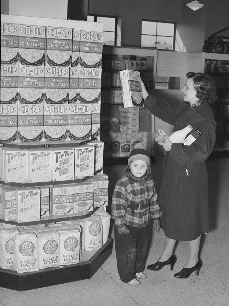 Resident At Greenbelt With Child In The Greenbelt Cooperative Grocery Store, Maryland By Russell Lee