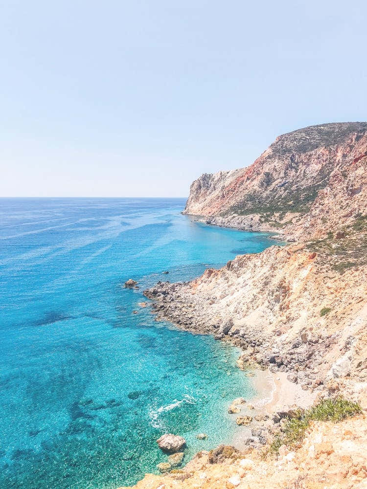 Milos, Greece I Wild boho nature mountain view and turquoise blue water on a dreamy beach paradise on Cyclades islands such as Santorini or Mykonos red sand beach overlooking the Mediterranean Sea view photography