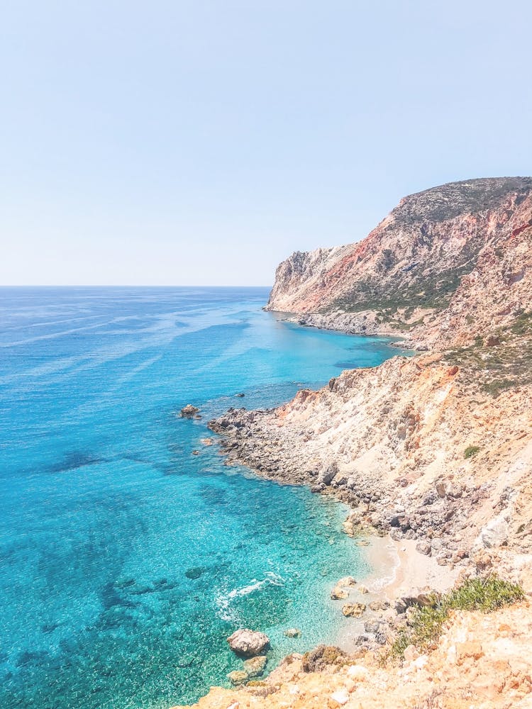 Milos, Greece I Wild boho nature mountain view and turquoise blue water on a dreamy beach paradise on Cyclades islands such as Santorini or Mykonos red sand beach overlooking the Mediterranean Sea view photography