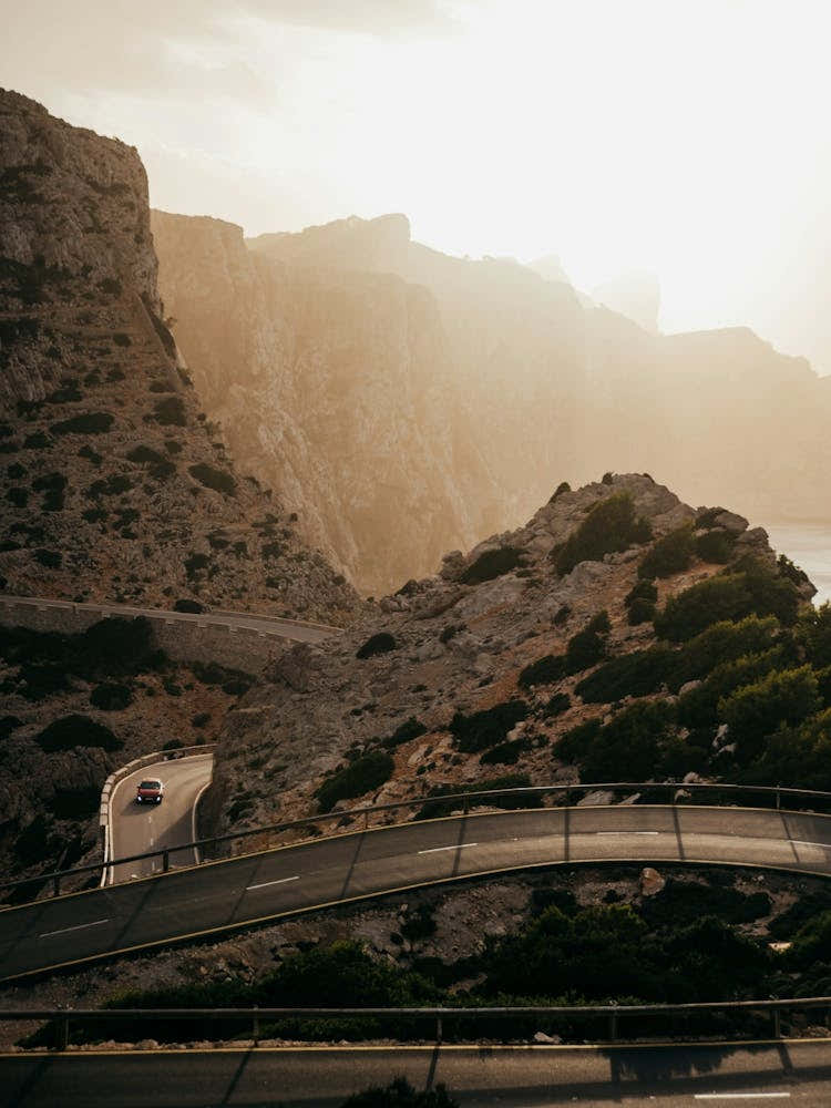 Formentor Mallorca - Car in sunset over the mountain roads of this beautiful mountain area
