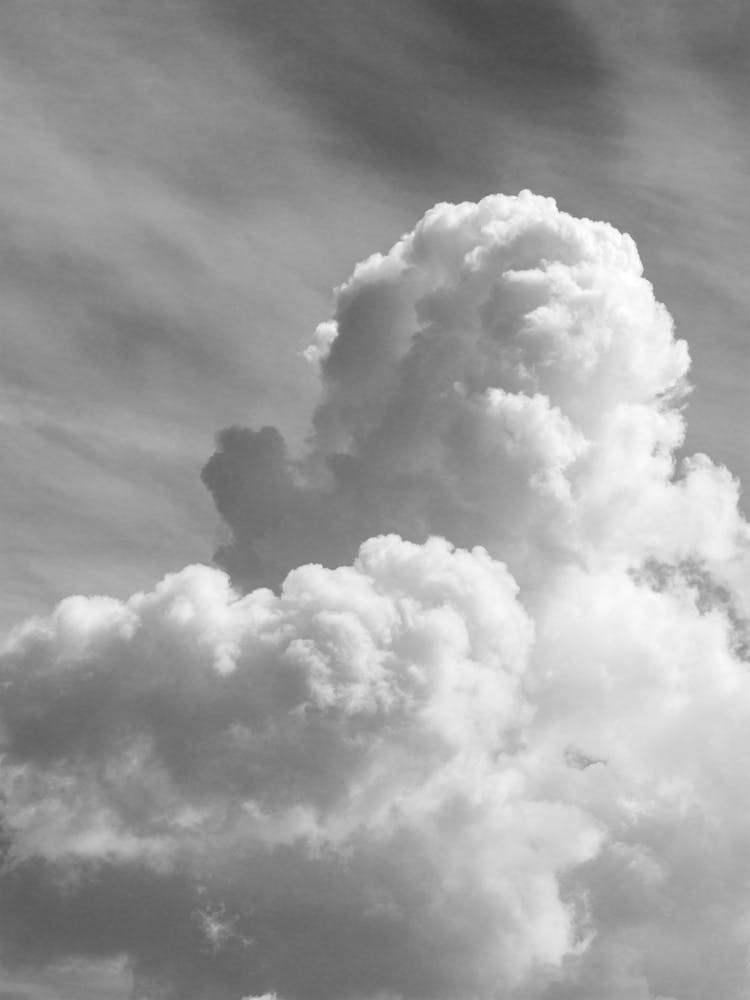 Black and white fluffy clouds in a clear sky - summer cloud nature and travel photography by Christa Stroo Photography