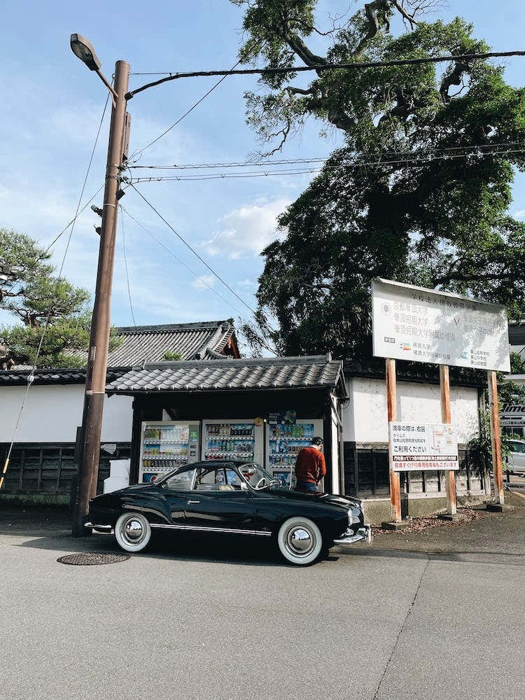 Old Japanese Car In Front Of A Shop