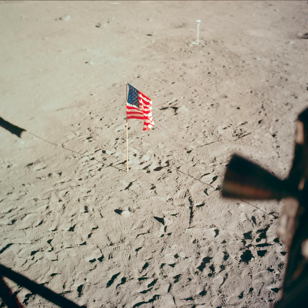 The Flag Of The United States And The Footprints Of Astronauts Neil A