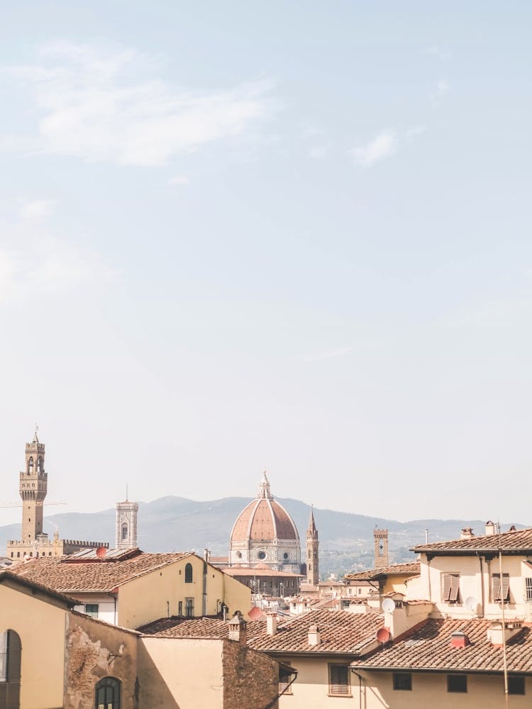 Florence, Italy I Skyline view of italian rooftops and Duomo Santa Maria del Fiore cathedral church photography with summer pastel aesthetics in sunny orange tones for living la dolce vita under the sun blue sky