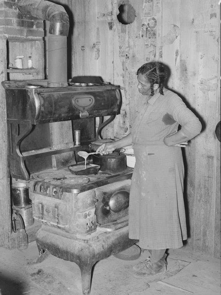 Southeast Missouri Farms, Woman Preparing Gravy In Corner Of Kitchen Sharecropper Cabin By Russell Lee