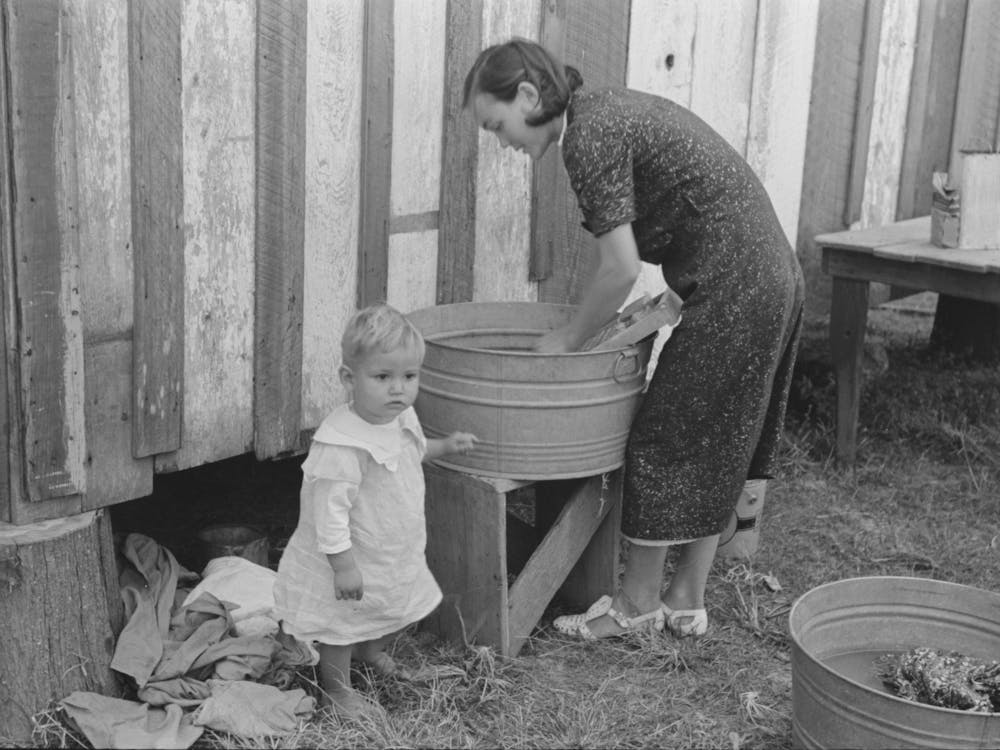Farmer S Wife Washing Clothes And Watching Son At Same Time, Note Construction Of House