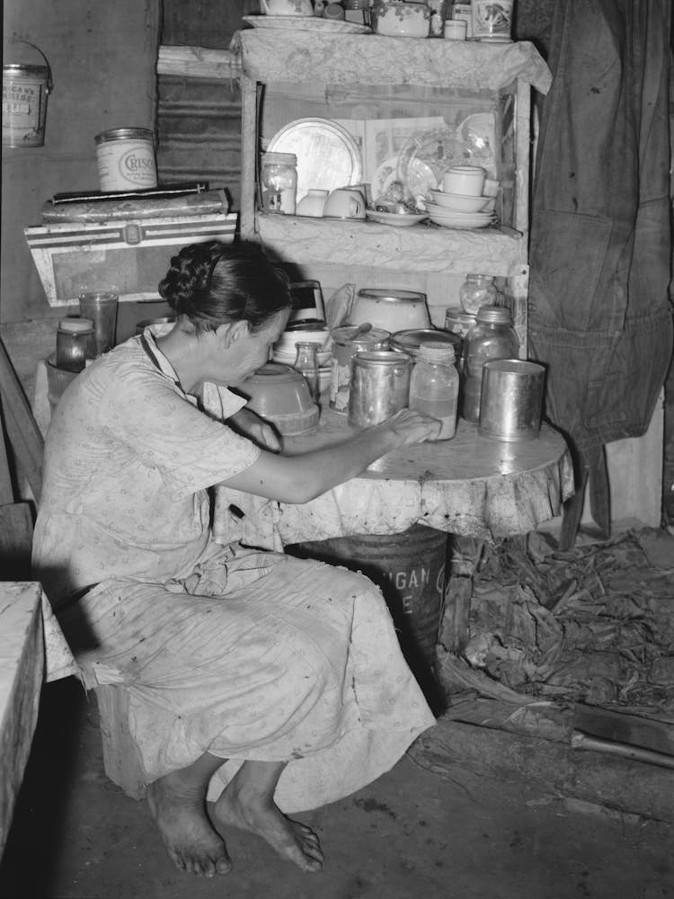 Resident Of Tin Town, Caruthersville, Missouri, Sitting At Kitchen Table By Russell Lee