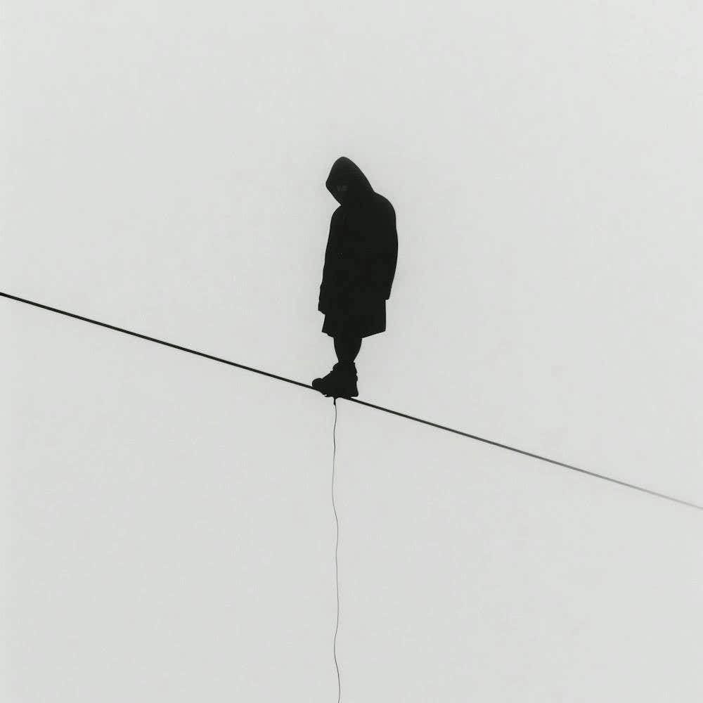 Silhouette Of A Man On A Wire