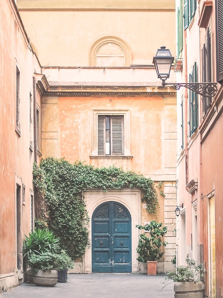 Rome, Italy I Colorful facade and tall door in a quiet Trastevere alley with pastel aesthetic tones and everyday charm photography capturing the beauty of Italian streets and the soul of la dolce vita