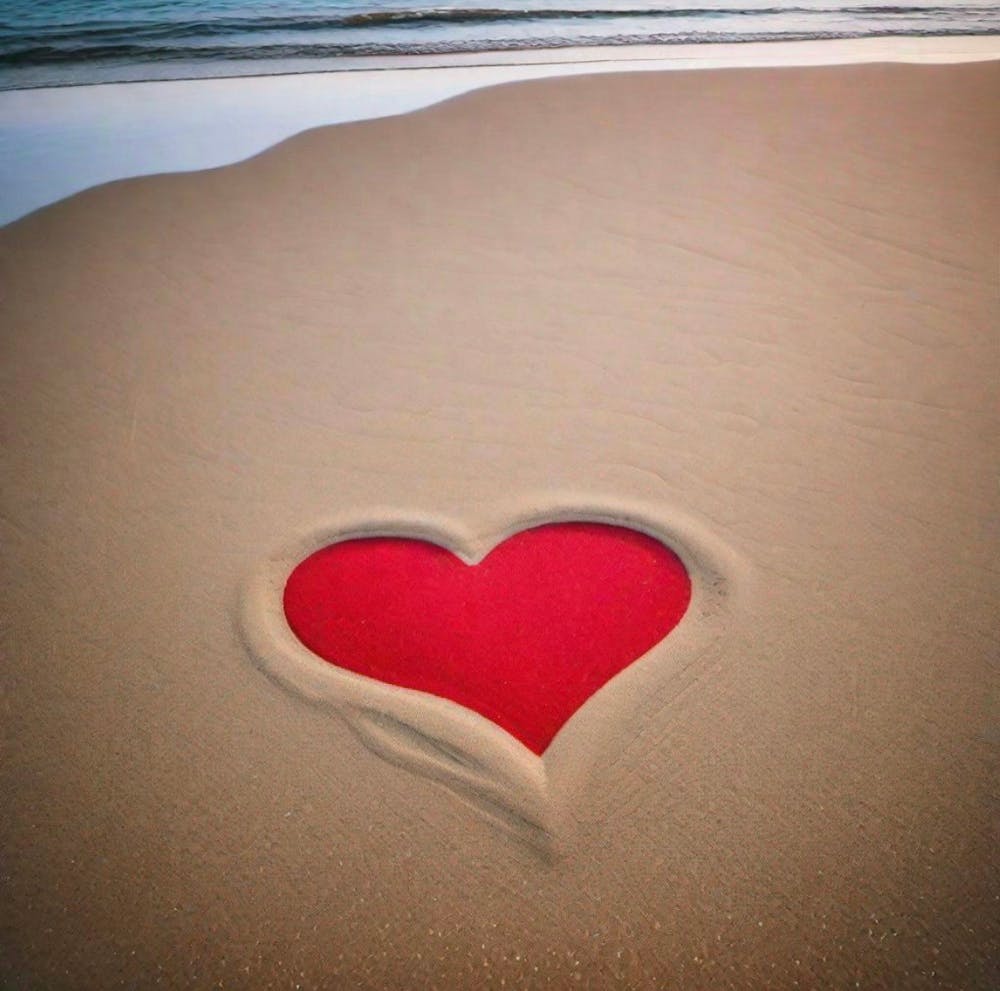 Red heart in the sand