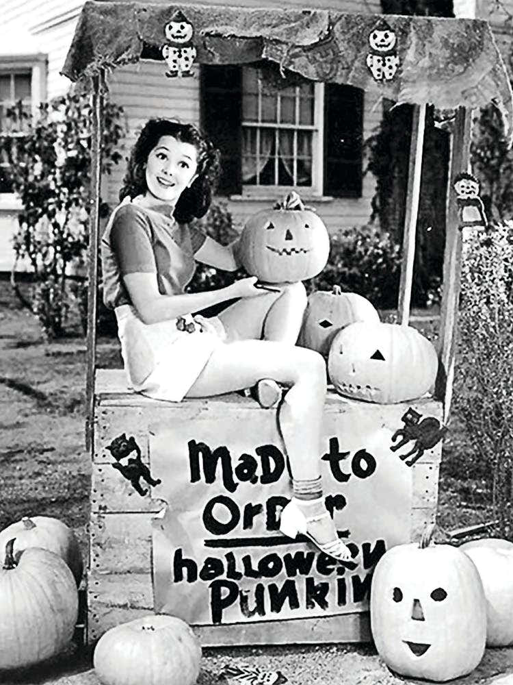 Pin Up Girl Pretending To Sell Carved Pumpkins