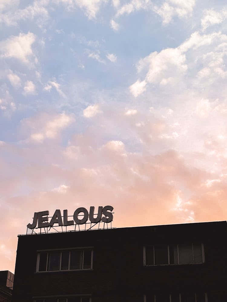 London, England I Jealous word in silhouette against a vibrant pastel pink and blue sunset sky minimalist urban architecture photography and the delicate boho bohemian aesthetic of a summer evening night