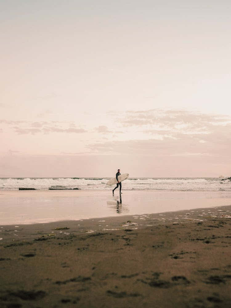 Surfer On Sunset Beach