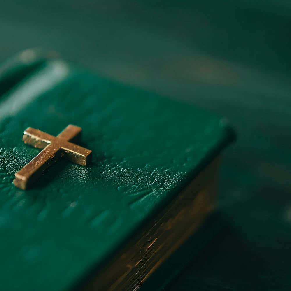 Gold Cross On A Green Bible