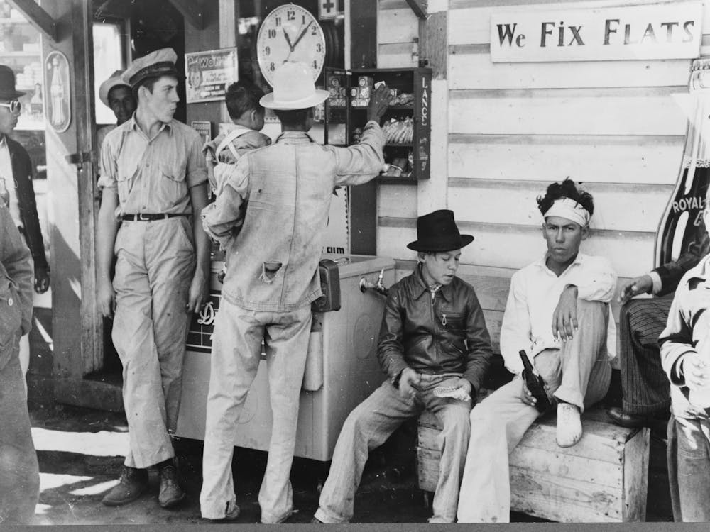 Mexican Migrants Drinking Cold Drinks And Buying Candy At Filling Station Where The Truck Which Is Taking Them To Their