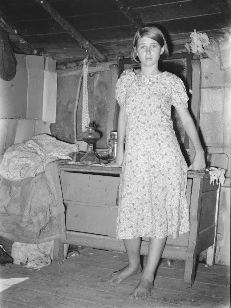 Girl Standing In Front Of Bureau In Shack Home, Tin Town, Caruthersville, Missouri By Russell Lee
