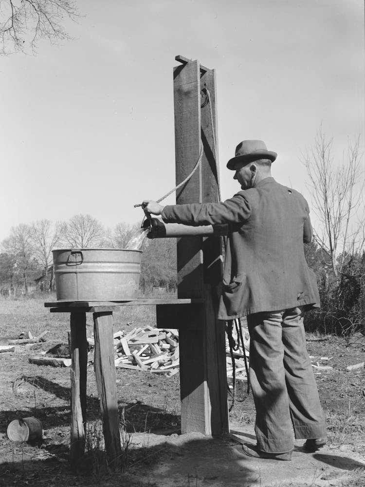 Ed Bagget, Sharecropper, Drawing Water From Well, Near Laurel, Mississippi By Russell Lee