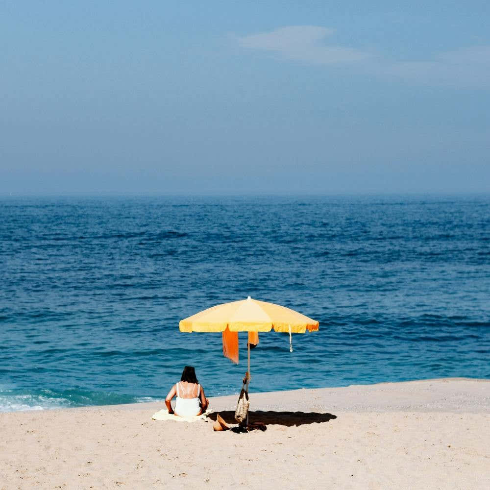The Yellow Parasol The Blue Sea And The Summer Beach In Portugal Square