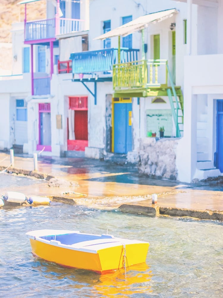 Milos, Greece I Yellow boat at fishing village of Klima with colorful houses on Mediterranean sea for a pastel summer aegean vibes aesthetic photography on Cyclades islands Santorini during Europe road trip